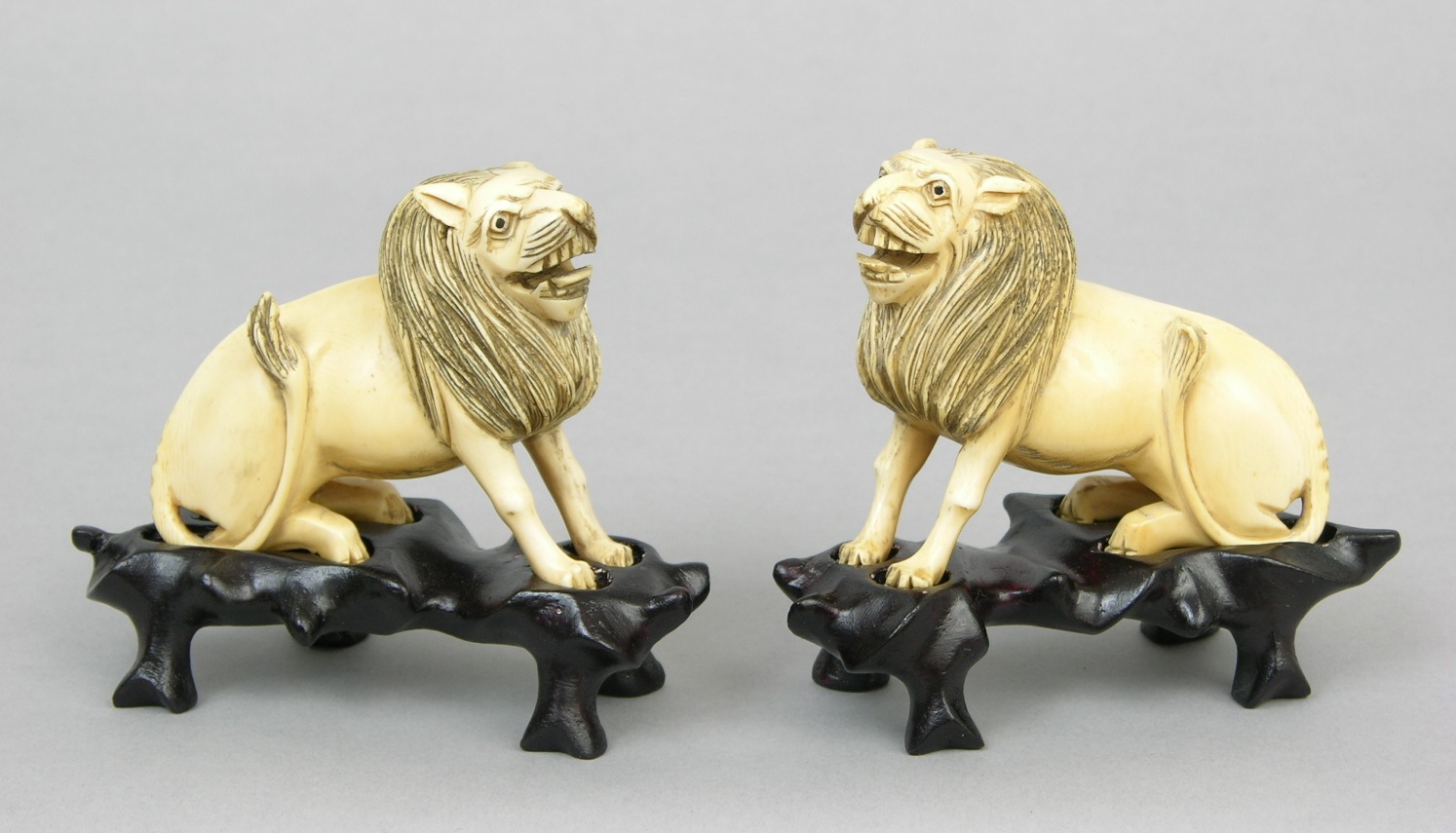 A Pair of Carved Ivory Lions on Stands, 11.16.07, Sold 293.25