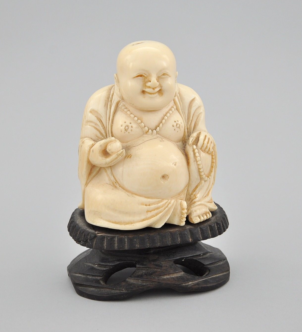 small carved ivory buddha