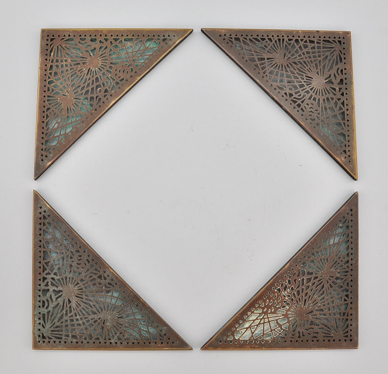 A Set of Four Tiffany Studios "Pine Needle" Blotter Corners, 11.21.09
