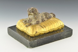 A Continental Bronze Miniature King Charles Spaniel on a Cushion